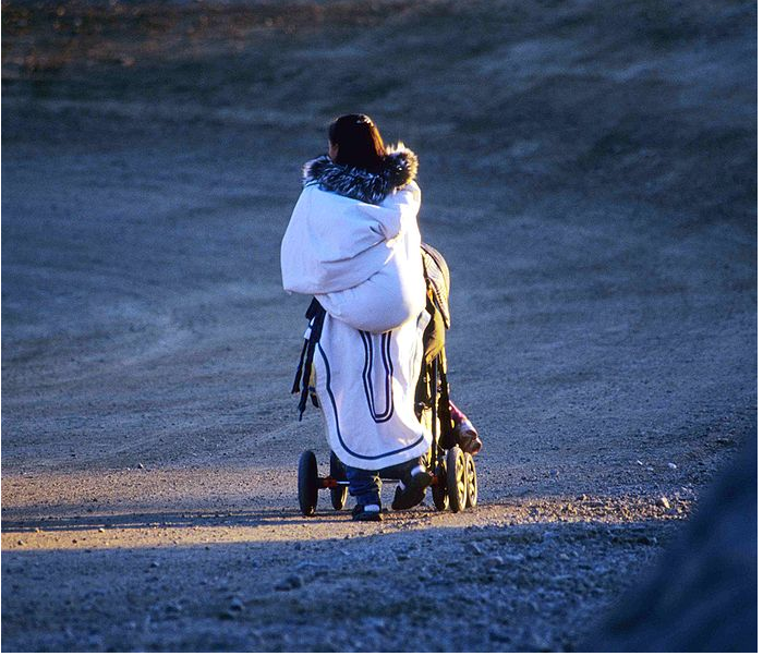 
        
        
        Image 1: Woman with <i>amautik</i> and stroller, Cape Dorset, Nunavut. Source: Wikimedia Commons.  Photo: Ansgar Walk.                 </i>