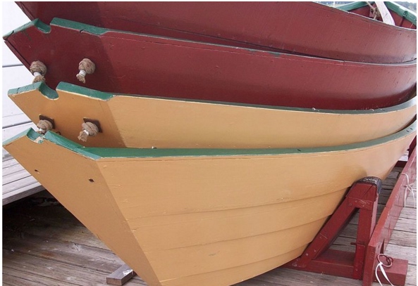 
                                   Image 1: <i>Dories</i>, stacked on one another, in Lunenburg, NS. Source: Wikimedia Commons. Photo: InAweofGod'sCreation                        