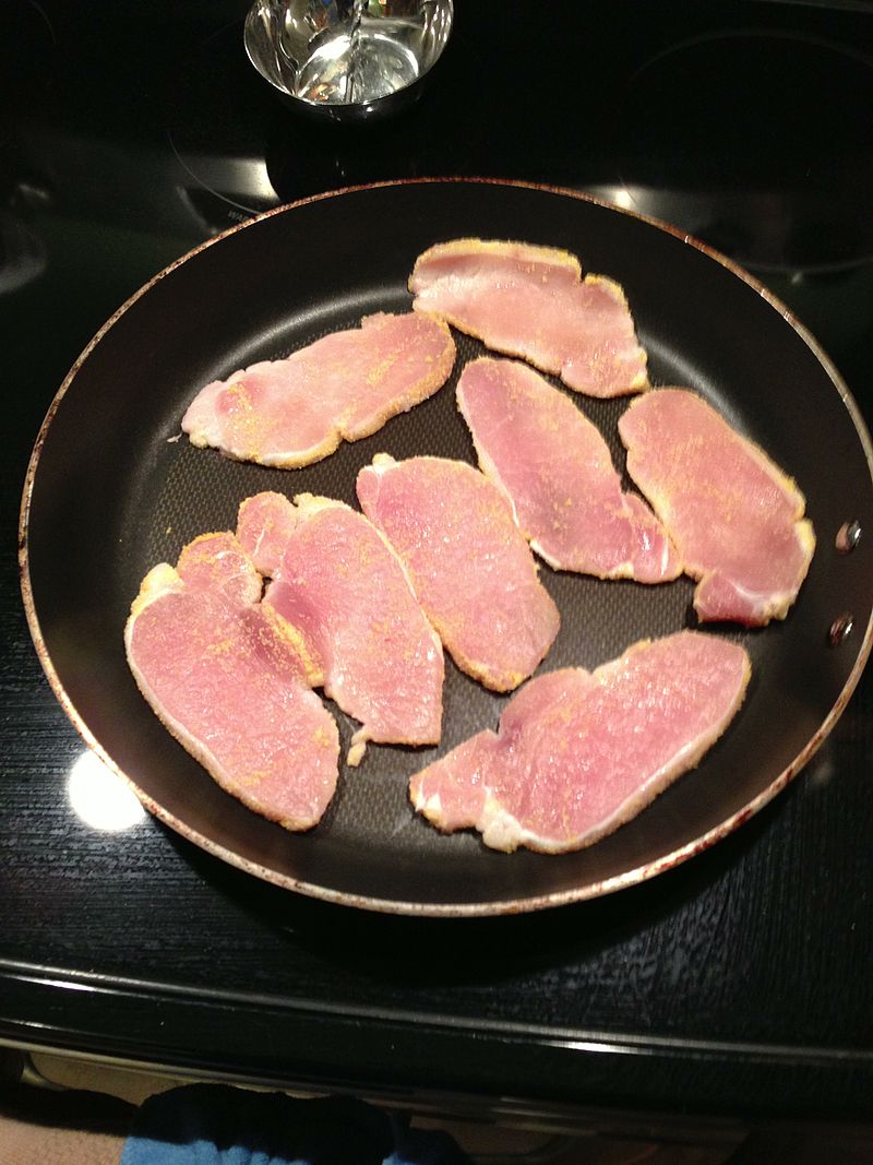 Image 1: Slices of <i>peameal bacon</i> in a pan. Photo: Kelapstick