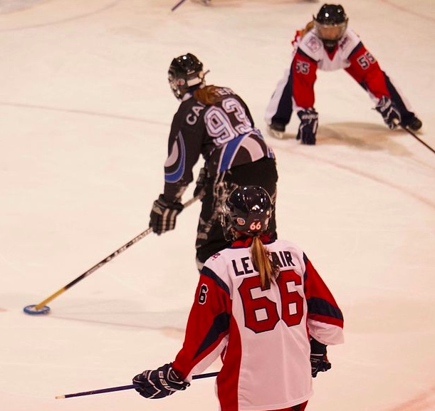 
        Image 1: <i>Ringette</i> players in action. Source: Wikimedia Commons. Photo: Genevieve2       