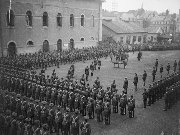 
        
        Image 1: King George V holds an investiture in Valenciennes, 5 December 1918, of the 7th Canadian Brigade (Royal Canadian Regiment, <i>Princess Patricia's Canadian Light Infantry</i>, 42nd and 49th Battalions (Source: Wikimedia Commons. Photo: McLellan, David, Second Lieutenant)            